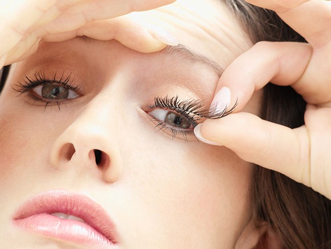 Makeup professionals apply lash glue to the false lash stri/band before placing it underneath your natural eyelashes as it creates a much more natural look!